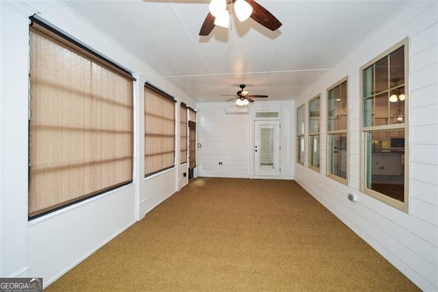 unfurnished sunroom with ceiling fan