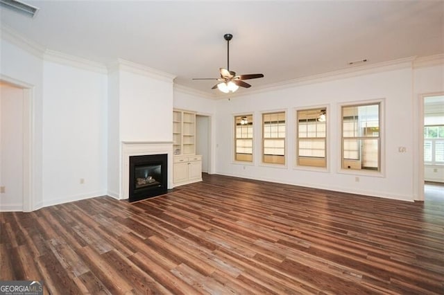 unfurnished living room featuring ceiling fan, dark hardwood / wood-style flooring, and ornamental molding