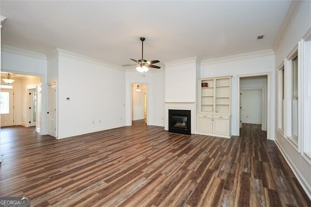 unfurnished living room with dark hardwood / wood-style floors, ceiling fan, and crown molding