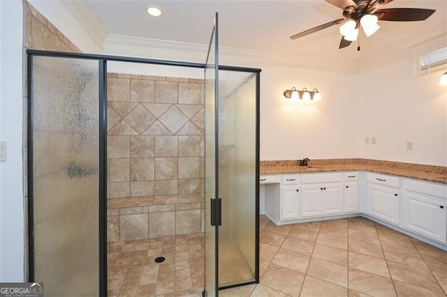 bathroom with ornamental molding, vanity, a shower with door, ceiling fan, and tile patterned flooring