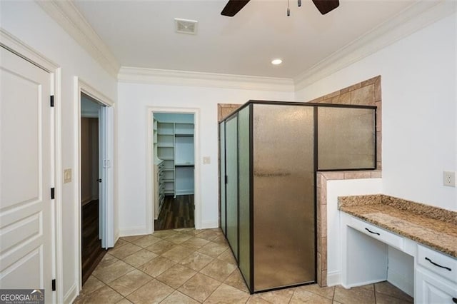 bathroom featuring tile patterned flooring, ceiling fan, ornamental molding, and a shower with door