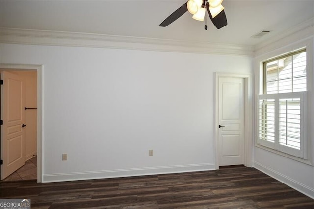 empty room with ornamental molding, ceiling fan, and dark wood-type flooring