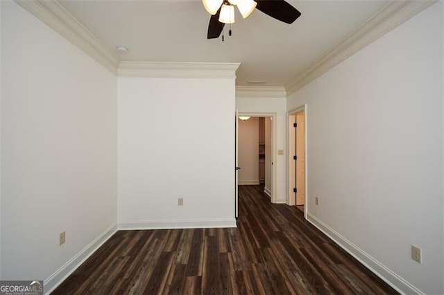 spare room featuring ceiling fan, dark wood-type flooring, and ornamental molding