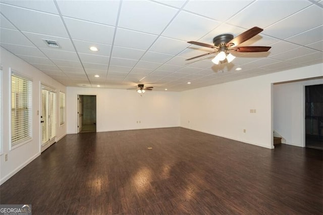 unfurnished room featuring a paneled ceiling, dark hardwood / wood-style floors, and ceiling fan