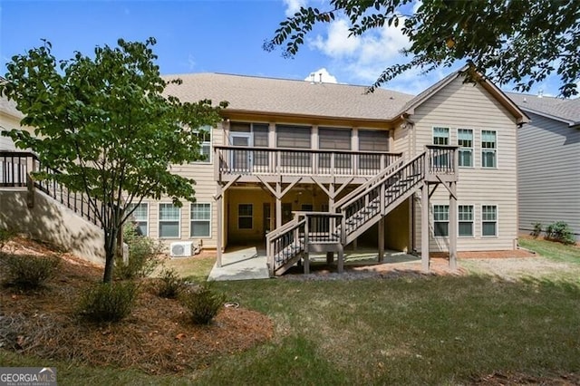 rear view of house featuring a patio area, a yard, and a deck