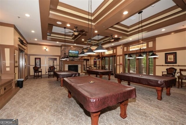 rec room with french doors, a raised ceiling, crown molding, a large fireplace, and carpet floors