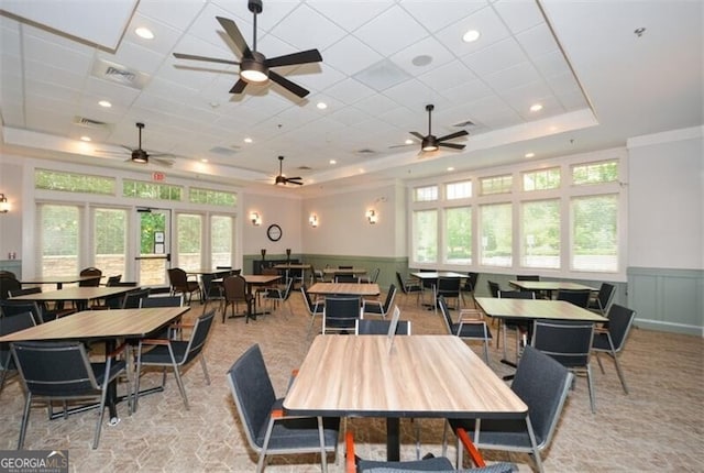 dining room featuring a raised ceiling and plenty of natural light