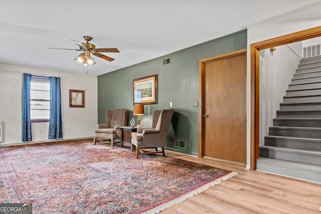 sitting room with hardwood / wood-style flooring and ceiling fan