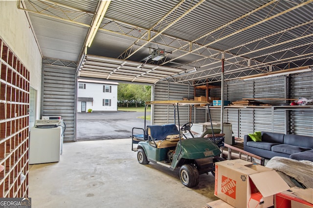 garage with washer / clothes dryer and a garage door opener