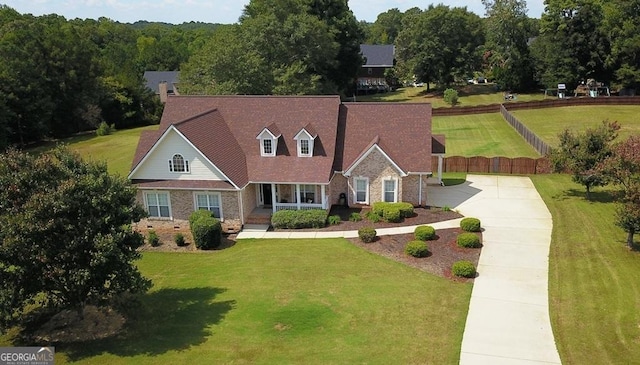 new england style home featuring a front yard