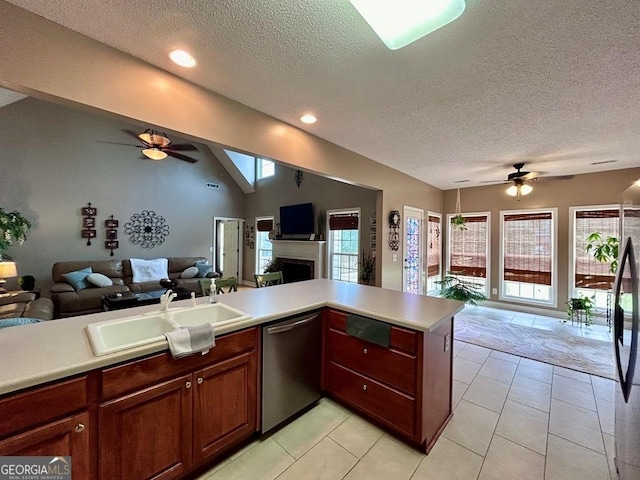 kitchen with lofted ceiling, sink, dishwasher, kitchen peninsula, and ceiling fan