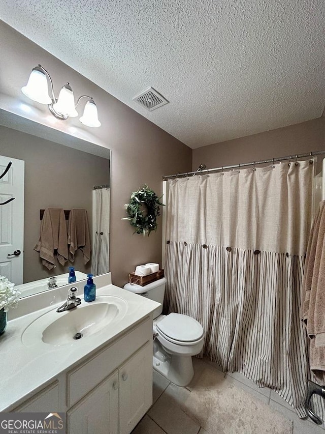 bathroom featuring vanity, a textured ceiling, curtained shower, tile patterned floors, and toilet