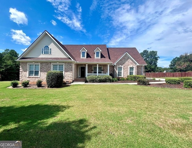 view of front facade featuring a front yard and covered porch