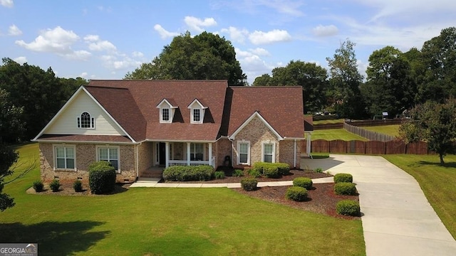 cape cod house featuring a front lawn