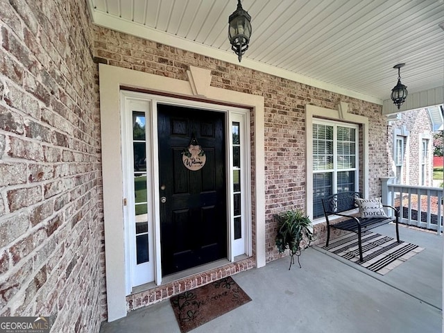 doorway to property featuring covered porch