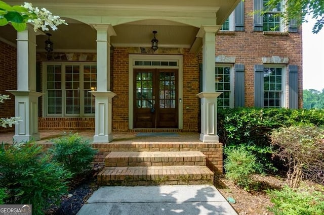 entrance to property featuring a porch and french doors