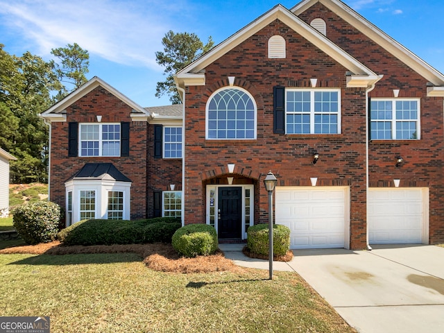 view of front facade with a garage and a front lawn