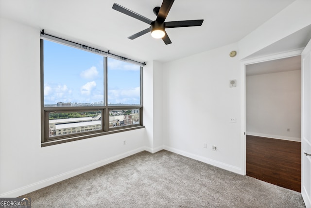 carpeted empty room featuring ceiling fan and plenty of natural light