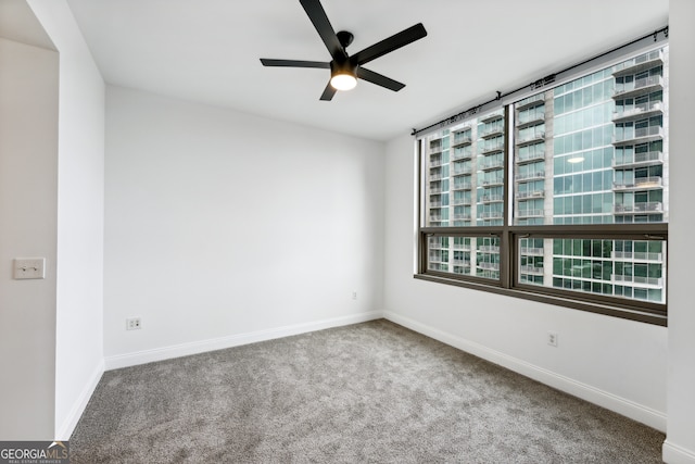 spare room with ceiling fan and carpet flooring