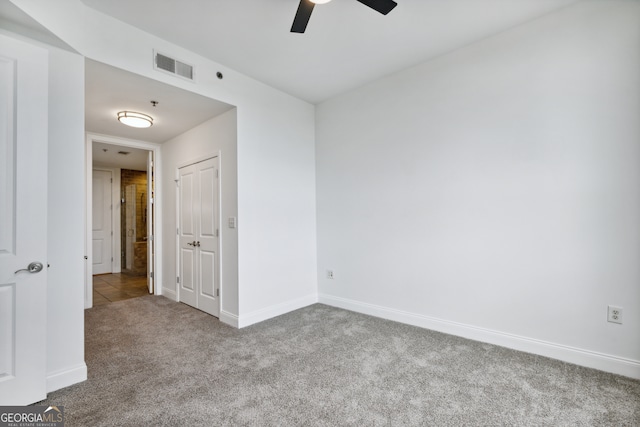 carpeted empty room with ceiling fan