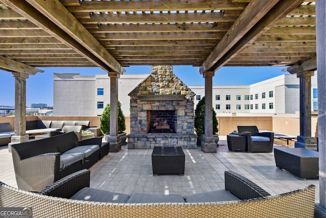 view of patio with an outdoor living space with a fireplace and a pergola