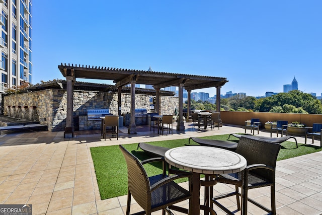 view of patio / terrace with a pergola and an outdoor kitchen