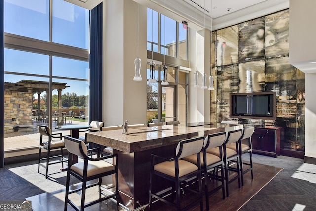 dining room with a high ceiling and dark parquet flooring