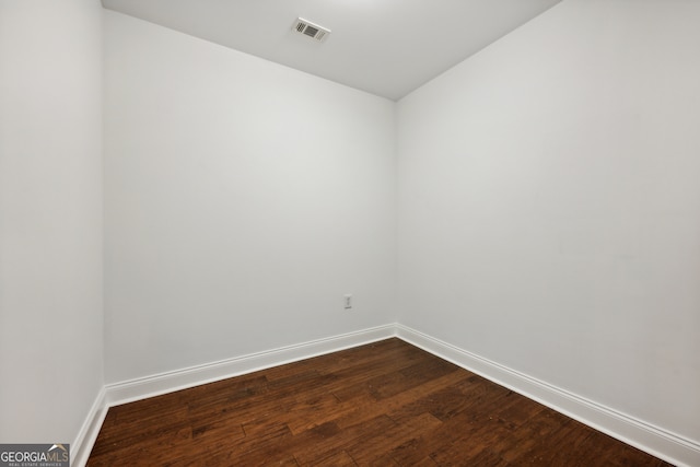 spare room featuring wood-type flooring