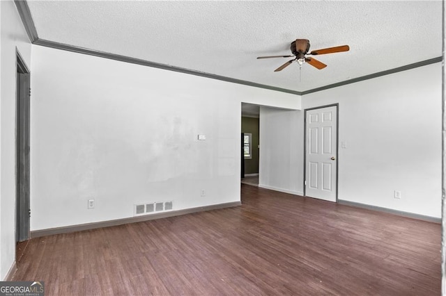 empty room featuring ceiling fan, a textured ceiling, dark hardwood / wood-style floors, and crown molding