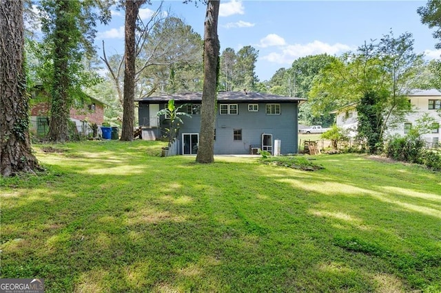 back of property featuring a lawn