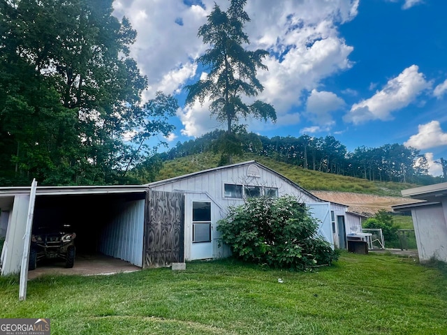 exterior space with a yard and a carport