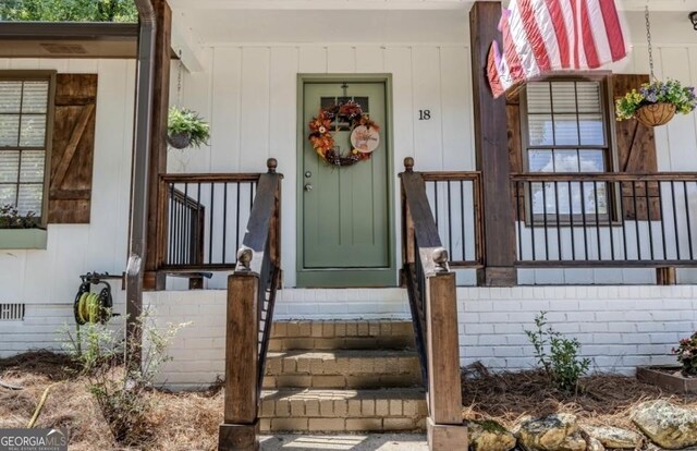 view of exterior entry with a porch