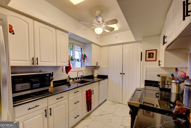 kitchen featuring ceiling fan, appliances with stainless steel finishes, sink, and white cabinetry