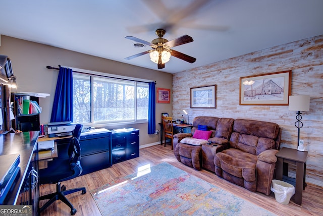 home office featuring light wood-type flooring and ceiling fan