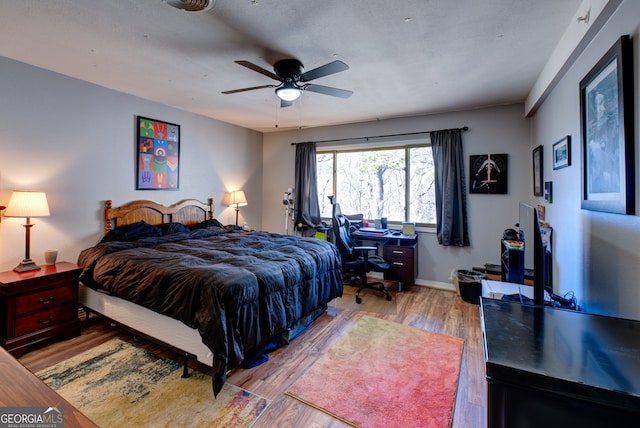 bedroom featuring light hardwood / wood-style floors and ceiling fan