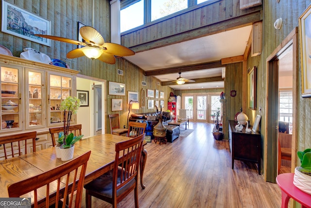 dining space with ceiling fan, beamed ceiling, and plenty of natural light