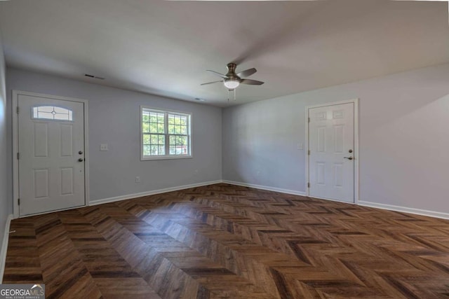 entrance foyer with dark parquet flooring and ceiling fan