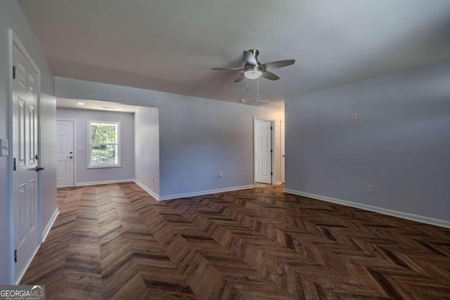 unfurnished room featuring dark parquet floors and ceiling fan