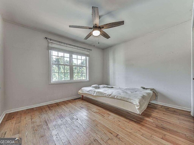 unfurnished bedroom with ceiling fan and light hardwood / wood-style flooring