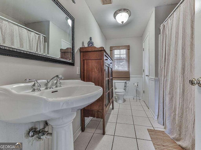 bathroom featuring tile patterned flooring and toilet