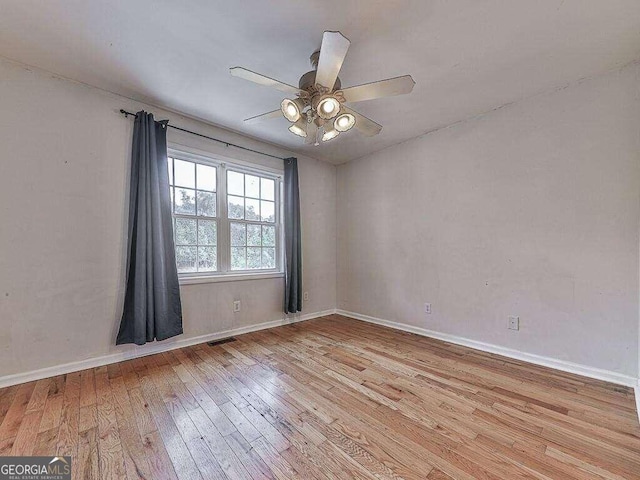 empty room with light hardwood / wood-style floors and ceiling fan