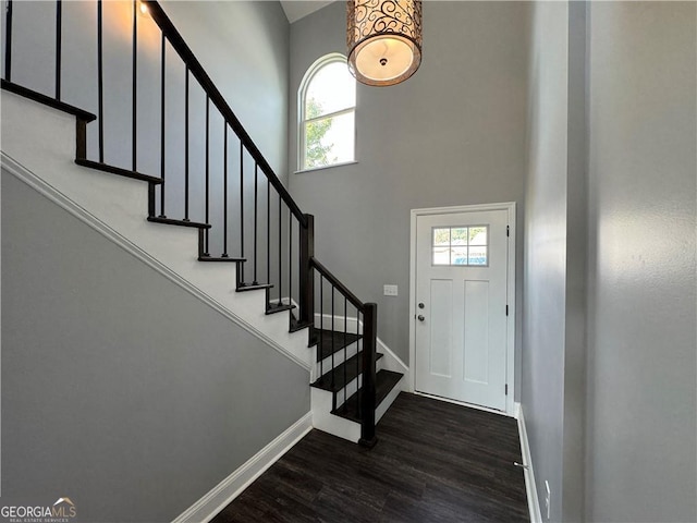 entrance foyer featuring a wealth of natural light and dark hardwood / wood-style flooring