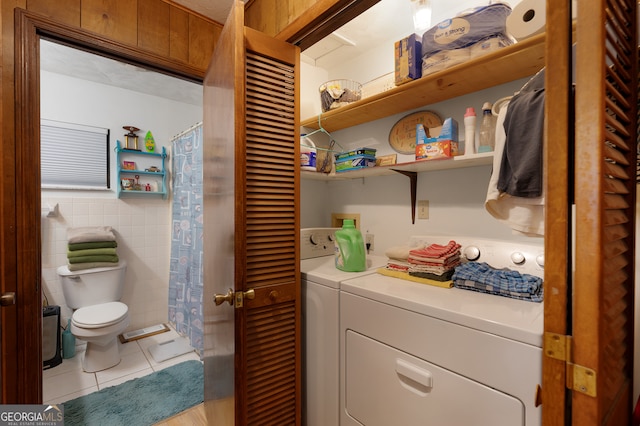 laundry room featuring light tile patterned flooring and washer and dryer