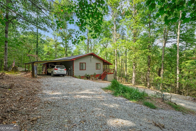 view of side of home with a carport