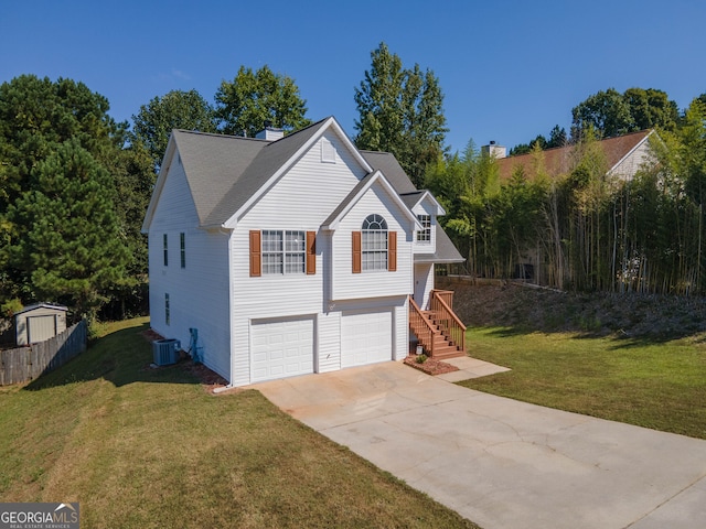 split foyer home with a garage, central AC unit, and a front lawn