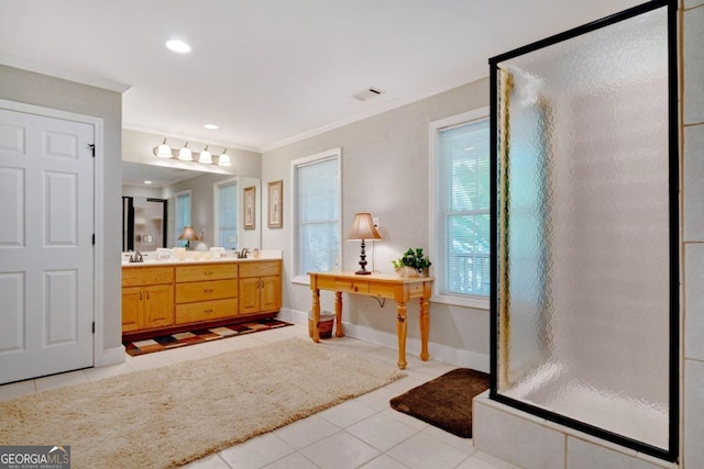 bathroom featuring crown molding, vanity, tile patterned floors, and an enclosed shower