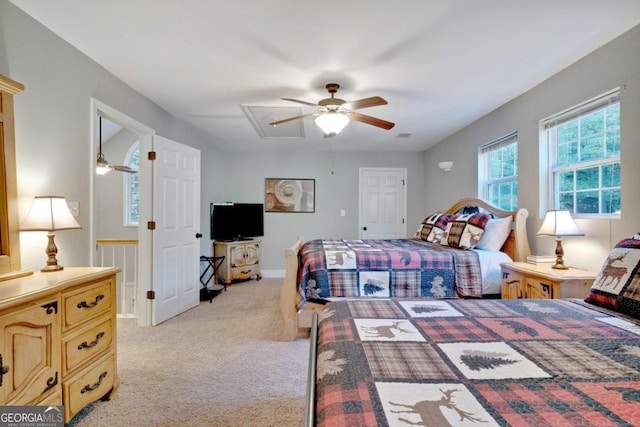 bedroom featuring light carpet and ceiling fan