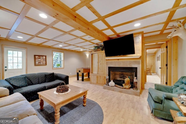 living room with coffered ceiling, beamed ceiling, light wood-type flooring, and ceiling fan