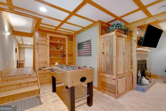 game room with coffered ceiling, beamed ceiling, and hardwood / wood-style flooring