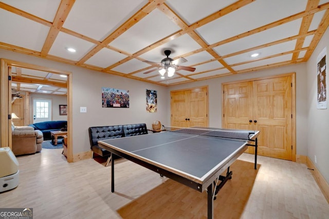 game room featuring light hardwood / wood-style floors, coffered ceiling, and ceiling fan